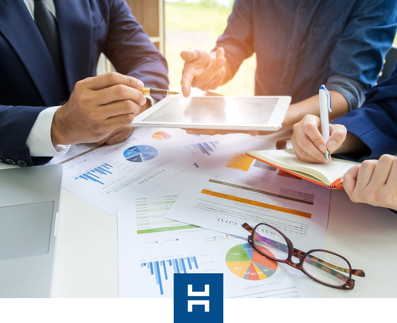 Valuation services analysis on laptop and documents